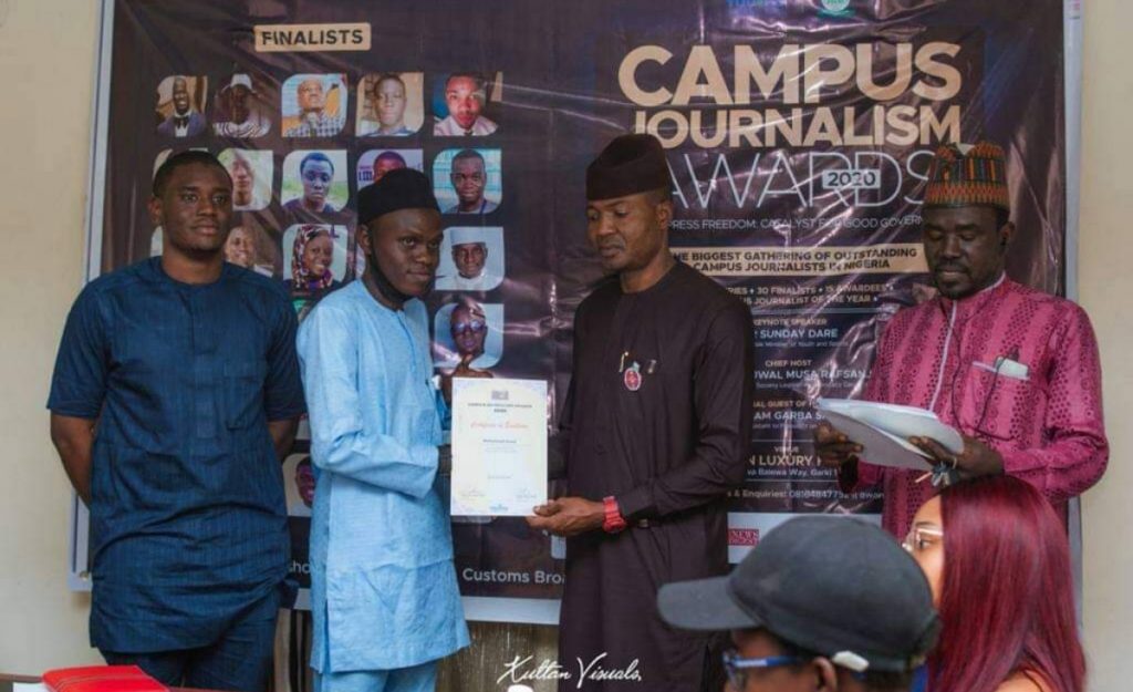 Muhammad Auwal Ibrahim (2nd left) receiving an award earlier in the year.
